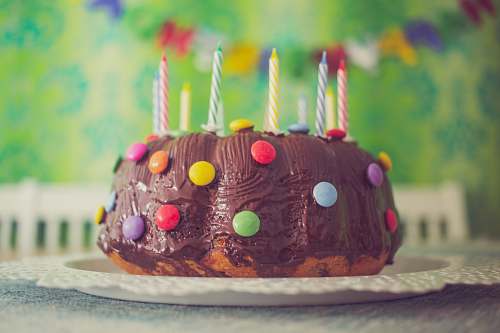 birthday cake chocolate cake with nips and candles in close-up photography dessert